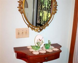 Small gilt metal oval mirror, wood wall shelf
