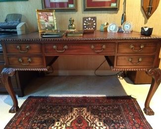 Vintage English mahogany partner's desk, with maroon tooled leather top.