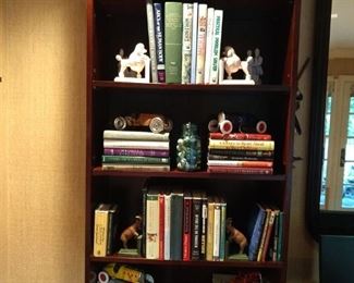 Huge, wall-eating mahogany bookcase, 10 1/2' long, filled with brain food and vintage cast iron collectibles. 