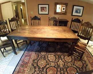 Antique, drop-leaf wooden farm table, with center drawer and six wooden side chairs. 
