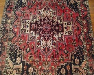 Vintage hand woven Persian Heriz rug, 100% wool face, measures 4' 8" x 7'.
