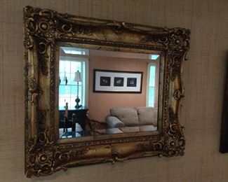 Gaudy gold wall mirror, with beveled glass.