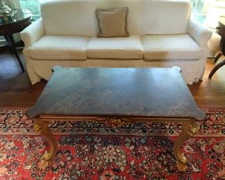 Slipcovered sofa to hide the sins of yesteryear or last weekend, wonderful gilt wood coffee table with Mickey Mouse ear marble top.