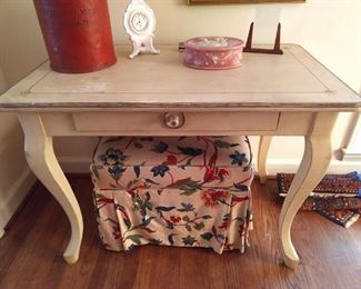 One of those "go anywhere" single drawer tables, painted correctly, with sweet honeybees at each corner - aww!                                                                                                               ;-)