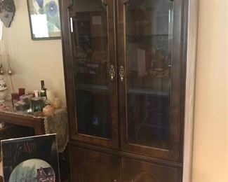 Two matching cherry china cabinets. Excellent condition. This is just one of them. Lots of candles too.