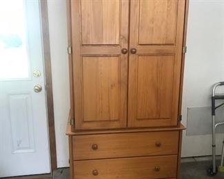 Armoir with shelves behind the doors.