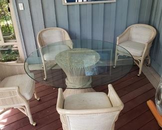 Patio table - glass top, bamboo base, 4 bamboo rolling chairs.