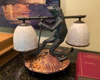 Maitland Smith dual shade bronze frog lamp resting atop a tortoise shell tone footed lily pad.