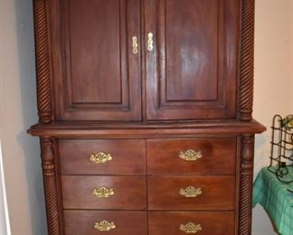 Beautifully Carved Armoire featuring Rope twist sides accented with Tudor Leaf Carvings, 8 Drawers and Shelving behind the Double Doors.