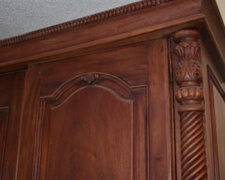 Beautifully Carved Armoire featuring Rope twist sides accented with Tudor Leaf Carvings, 8 Drawers and Shelving behind the Double Doors.