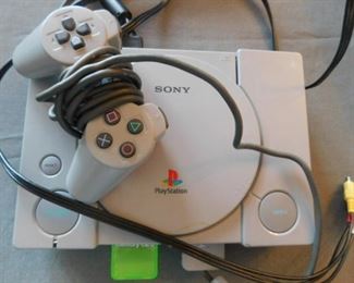 Play Station one with a memory card and one controller