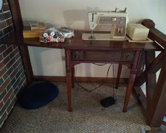 Singer sewing machine.  She needs some work but has all her accessories, and is priced accordingly