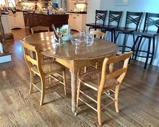 Vintage Round Oak table and 4 antique cane  seat chairs - table is shown as oval w/2 leaves in