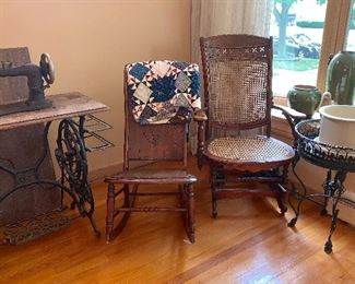 Vintage sewing machine and stand, Quilt, Vintage rockers and cane back glider, wrought iron planter.