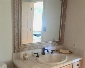  There are several bathroom vanities and mirrors.