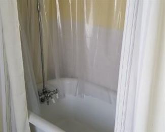 Cast iron claw foot bathtub with shower surround