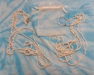 Bag of fresh water pearls - 4 strands ranging from small ring to long rope.  3 baroque, 1 teardrop.