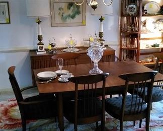 Mid century modern dining table with six chairs, floral area carpet