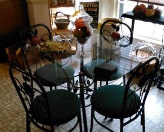 Great glass top sun room table with four chairs