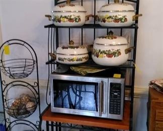 Baker's rack with cookware, microwave and 3 basket stand.