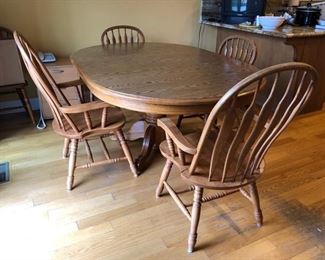 Wood kitchen table with laminate top, 2 leafs and 6 total chairs (2 captains and 4 armless)