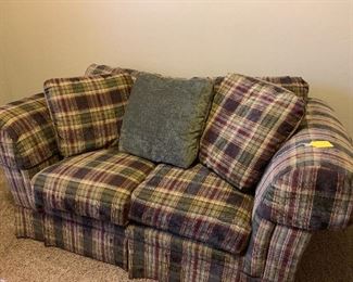 This couch has no tears or stains.  It looks like and feels like it has NEVER been sat in!