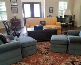 Sunny yellow love seat, antique rug, blue chairs with ottomans are sill all available