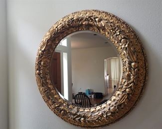 Ornate gold toned circular mirror