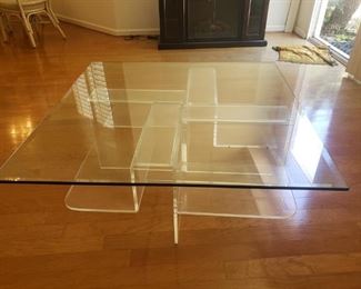 Square glass coffee table with plexiglass base