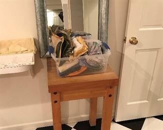Butcher block table; cool metal-framed mirror.