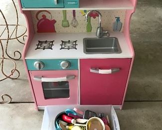 Child's play kitchen with many accessories.
