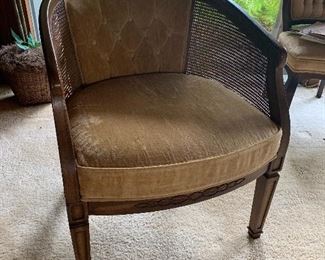Pair of Mid Century barrel back chair with cane sides and upholstered backs and seats (only one showing)