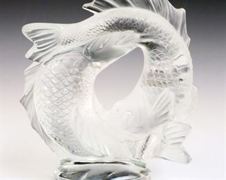 Lot 5: A Lalique Crystal "Deux Poisson" Sculpture.  Figure of two fish, swimming in a continuous circle.   Minor surface scratches.  Etched signature "Lalique France".