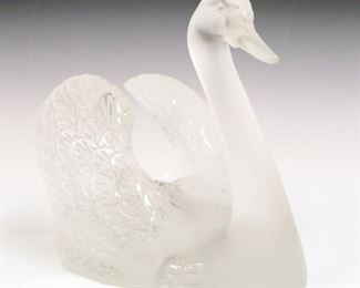 Lot 6: A Lalique Crystal Swan.  Figure of a swan with wings slightly raised.  Signed "Lalique France".  Minor wear and surface scratches.  9 3/4" high.