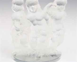 Lot 8: A Lalique Crystal "Luxembourg" Sculpture.  Depicts Three putti.  Etched signature "Lalique France".  Very minor wear/surface scratches.  8" high. 