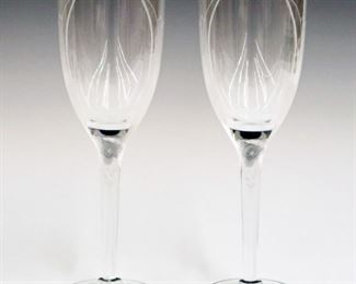 Lot 14: A Pair of Lalique Crystal "Angel" Flutes.  With frosted angel motif.  Etched signature "Lalique France".  Overall condition is good.  8" high.  