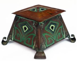 Lot 38: An Arts & Crafts Inkwell.  Copper with enameled decoration.  Wear and minor damage, lacks insert.  3 1/4" high.  
