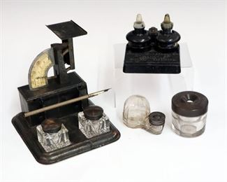 Lot 40: Four Advertising Inkwells.  Including 1 with glass domed body, 1 Sengbusch Self-Closing Ink Stand, 1 Sullivan-McKeegan Co. Drawing Materials set, and 1 Gem Postal Scale/inkwell set.  Wear to each, some corrosion/oxidation.  Up to 6 1/2" x 7" x 7" high.
