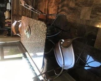Iron base granite top table $275, Three iron and leather chairs $150