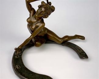 Art Nouveau bronze "Nude on Horseshoe" signed