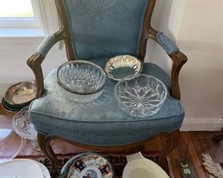 Various platters, crystal bowls, serving platters. Antique blue chair (seat needs to be recovered)