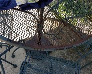 #32 metal table w 4 chairs as is rust $75.00
without umbrella