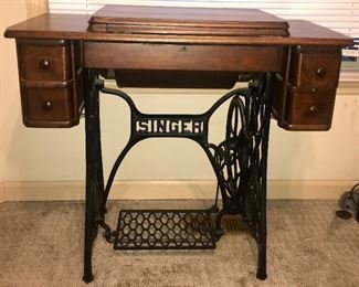 Antique Singer sewing machine cabinet with original treadle base 