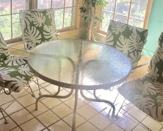 Glass top table and 4 wrought iron spring chairs
