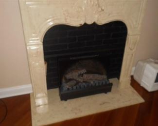 Cultured marble mantle with fireplace insert.  Visual  with fire light and generates some heat