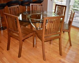 Glass and metal table and 6 wooden chairs