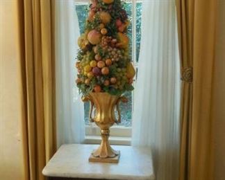 Marble top table with fruit topiary