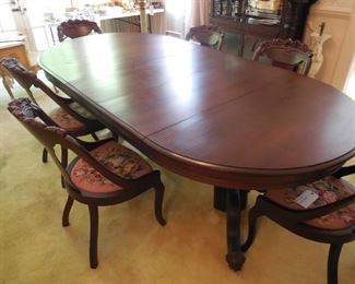 Mahogany dining table with six needlepoint chairs and 2 host chairs