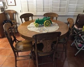 Kitchen Table with 4 leaves and multiple chairs.