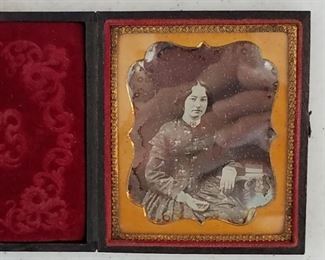 1840s/50s daguerreotype photograph of a seated woman with books in a pressed case. In very good condition.